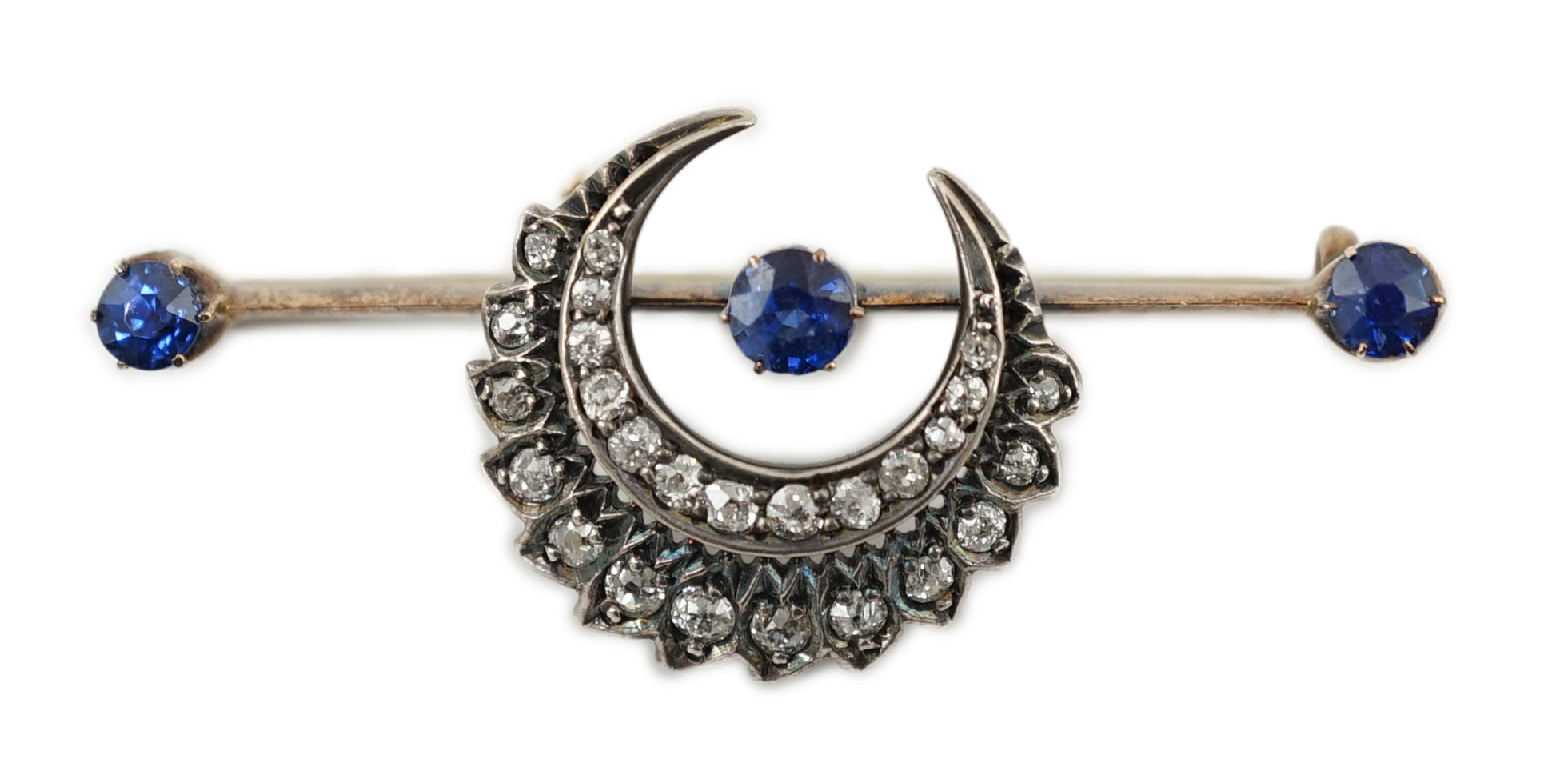 A Victorian gold and silver, three stone sapphire and diamond cluster set double crescent bar brooch